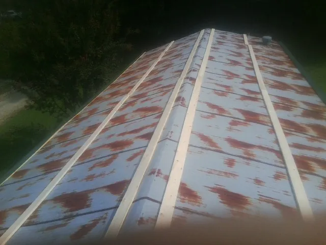 Rusted metal roof panels with new wood purlins before replacement — Storm Damage Roof Repair in Bronx by Roofing Brothers